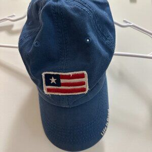 This is a Life is Good Adult Unisex American Flag Tattered Chill Cap in dark